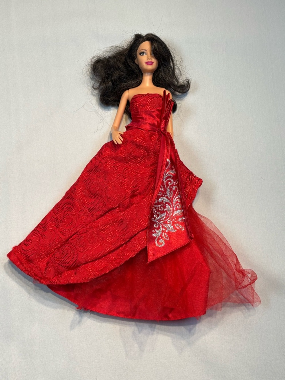 Barbie wearing a 2012 Holiday Barbie doll dress